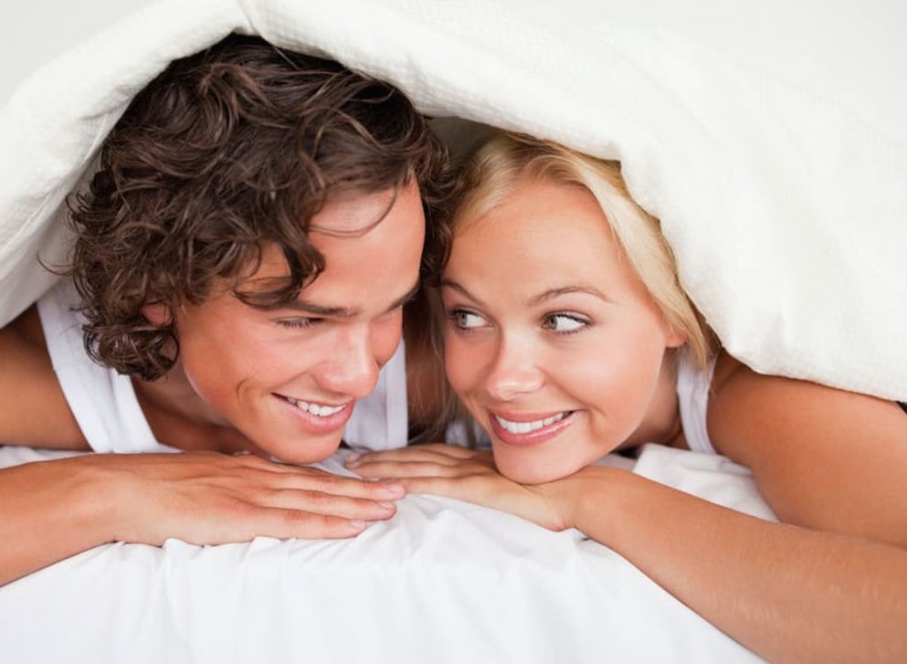 couple souriant dans un lit